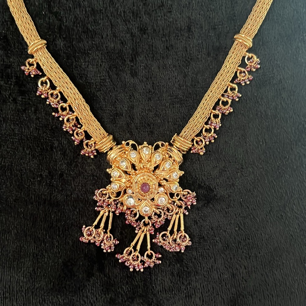 Gold tone necklace and earrings set with red beads and rhinestones